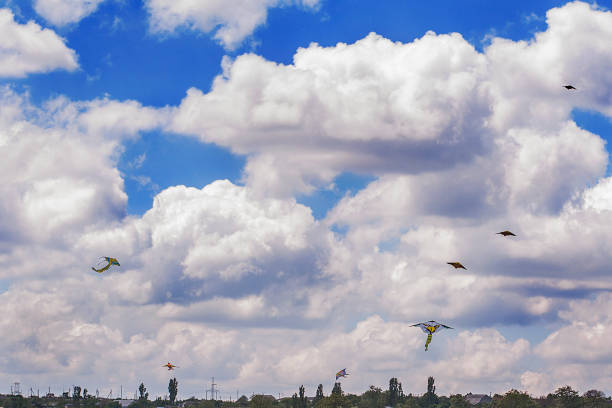 A kite flying in the sky among the clouds on a rope A kite flying in the sky among the clouds on a rope красота stock pictures, royalty-free photos & images