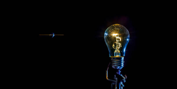 istock cosmic explosion of a burning light bulb with flying splinters and smoke on a black background with a flash 1127195802