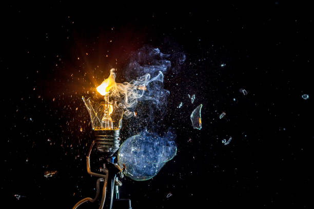 istock cosmic explosion of a burning light bulb with flying splinters and smoke on a black background with a flash 1127196566