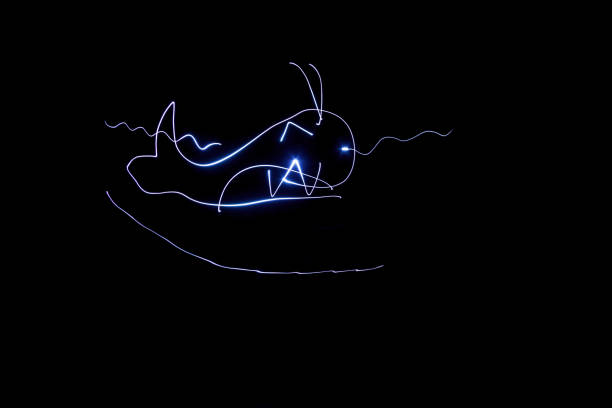 istock Kids freezelight drawn by light on black background 1127197506