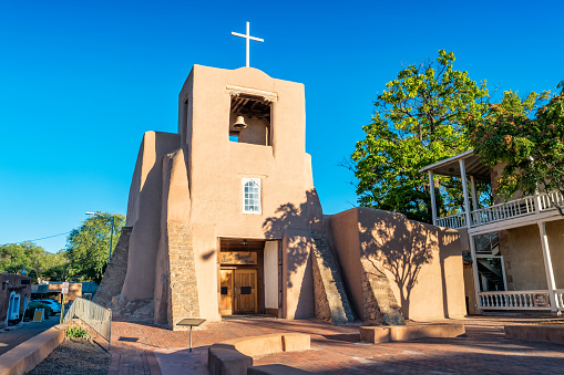 Stock photograph of the historic, early 17th century San Miguel Mission in downtown Santa Fe, New Mexico USA on a sunny day.