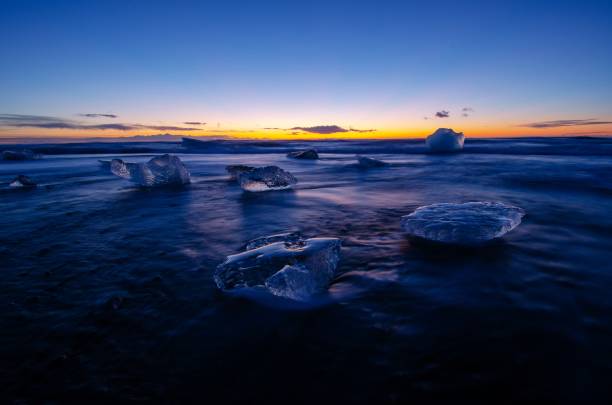 istock Ocean wave washing over icebergs during Sunrise 1127202519