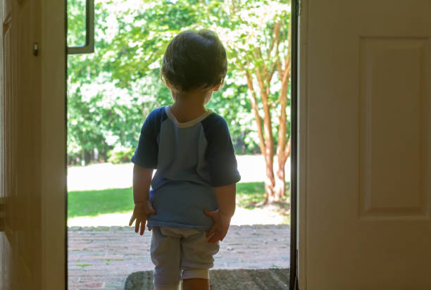 istock Toddler boy stading in the doorway 1127202956