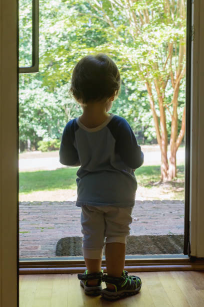 istock Toddler boy stading in the doorway 1127202959