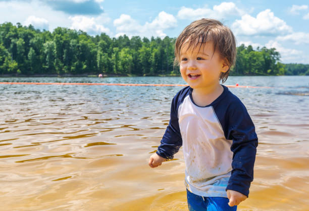 istock Toddler boy playing in a lake on a summer day 1127202976