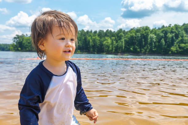 istock Toddler boy playing in a lake on a summer day 1127202984