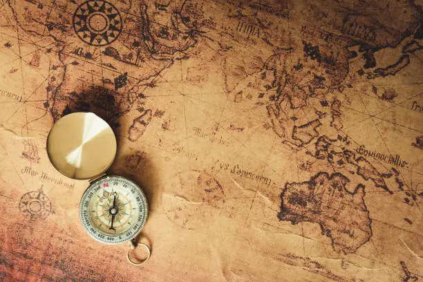 Photo of Navigator explore journey with compass and world map., Travel destination and planning vacation trip., Vintage concept.