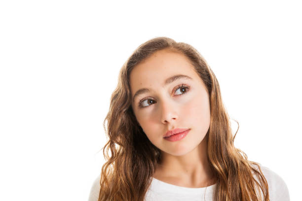 Beautiful young girl thinking or having an idea isolated on white background