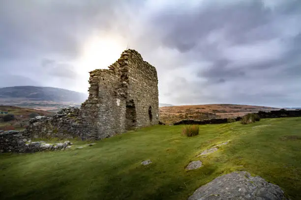 Gorgeous sunset view of the crumbling walls of Dolwyddelan Ruins in Snowdonia National Park, Wales UK.