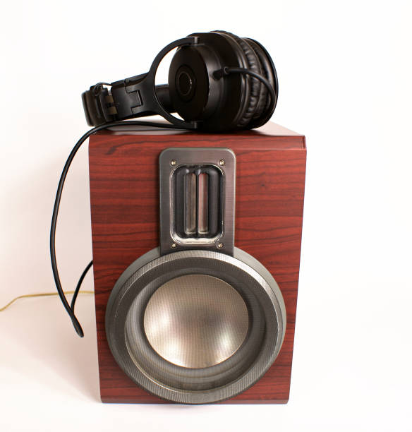 istock Audio system. Headphones lying on an audio speaker on a white background. 1127208856