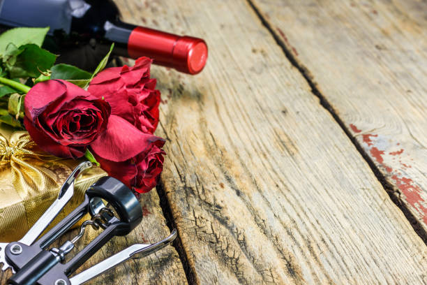 istock Red roses, a bottle of wine, corkscrew and gift. Valentines day 1127210055