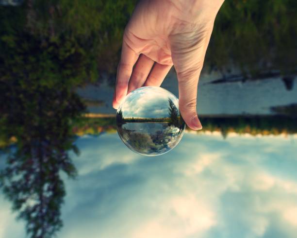 istock Image upside-down but right side up in glass crystal ball 1127218780