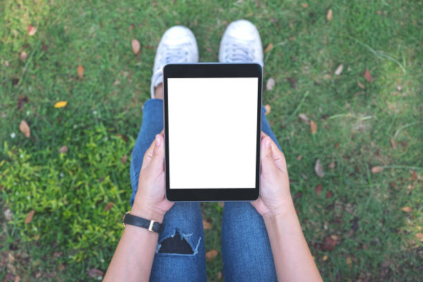 istock a woman holding and using black tablet pc with blank white desktop screen 1127219518