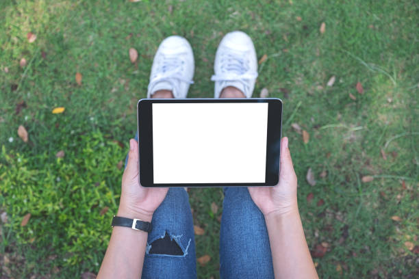 istock a woman holding and using black tablet pc with blank white desktop screen 1127219533