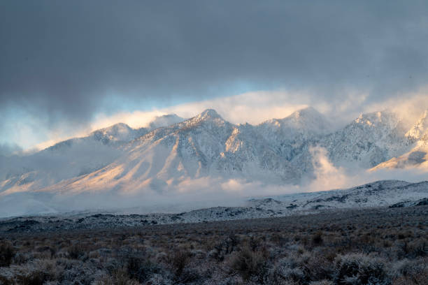istock clouds around snowy peaks of mountain range 1127221375