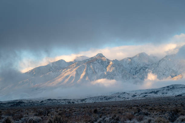 istock clouds around snowy peaks of mountain range 1127221382