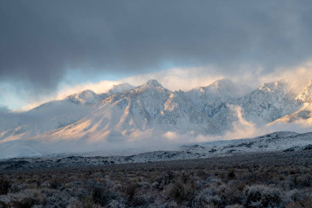 istock clouds around snowy peaks of mountain range 1127221385