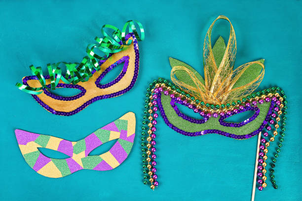 Diy Masquerade mask Mardi Gras, Fat Tuesday. Gift idea, decor Mardi Gras. Carnival mask cardboard, sequins, paper, beads. Step by step. process childrens crafts. Top view. Green yellow purple