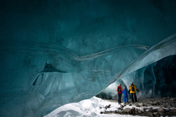 istock Family exploring a stunning glacial ice cave 1127234735