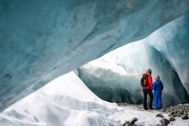 istock Family exploring a stunning glacial ice cave 1127234750