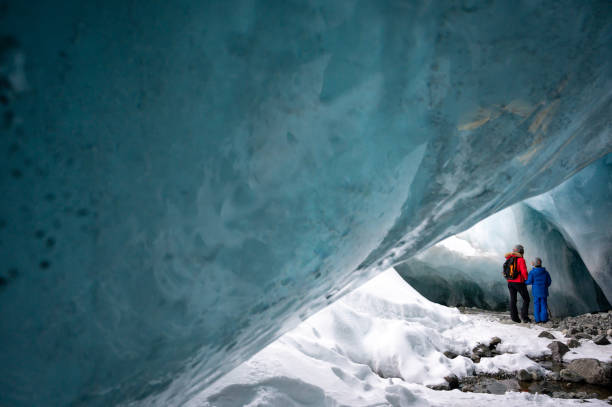 istock Family exploring a stunning glacial ice cave 1127234767