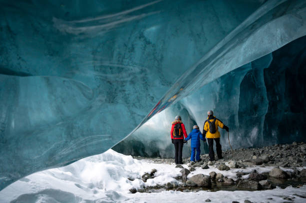 istock Family exploring a stunning glacial ice cave 1127234780