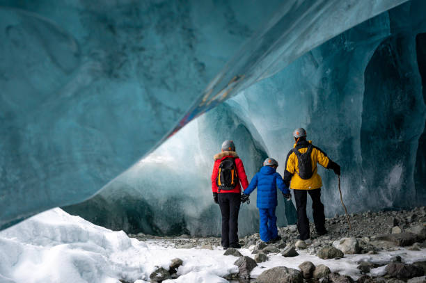 istock Family exploring a stunning glacial ice cave 1127234782