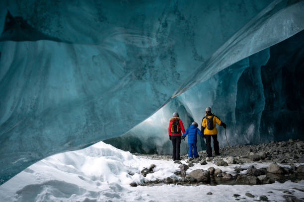 istock Family exploring a stunning glacial ice cave 1127234789