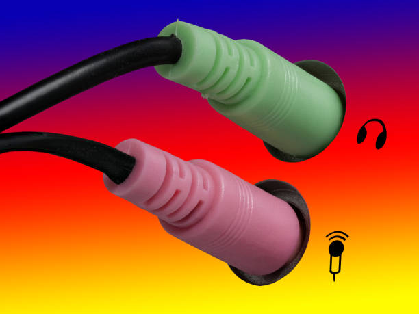 istock 0636 Plug for headphones, headsets and microphone on a computer, blue, red and yellow background, right side 1127237005