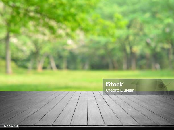 Empty Wooden Platform And Green Spring Blurred Abstract Background Stock Photo - Download Image Now