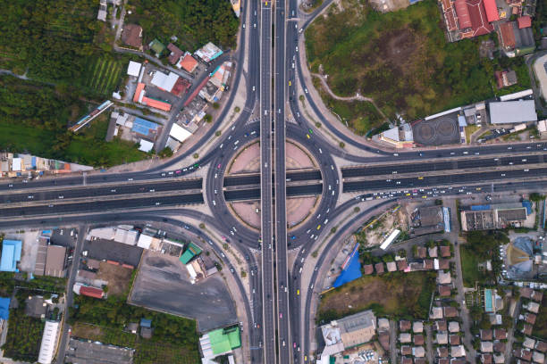 istock Aerial view of highway junctions with roundabout. Bridge roads shape circle in structure of architecture and transportation concept. Top view. Urban city, Bangkok at sunset, Thailand. 1127238943