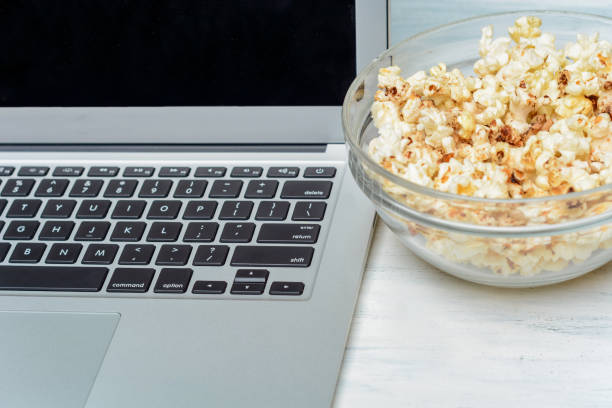 istock Popcorn and laptop playing movie. 1127239819