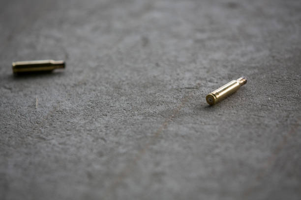 istock Empty bullets from a pistol, gun or rifle laying on the floor after shooting 1127240013