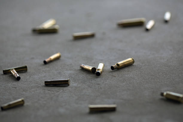 istock Empty bullets from a pistol, gun or rifle laying on the floor after shooting 1127240036