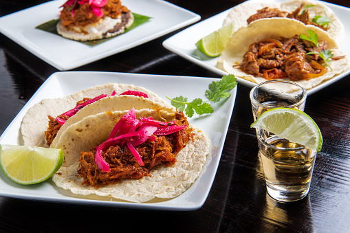Assorted Mexican tacos -beef, al pastor, cochinita pibil (mexican pulled pork) and tequila