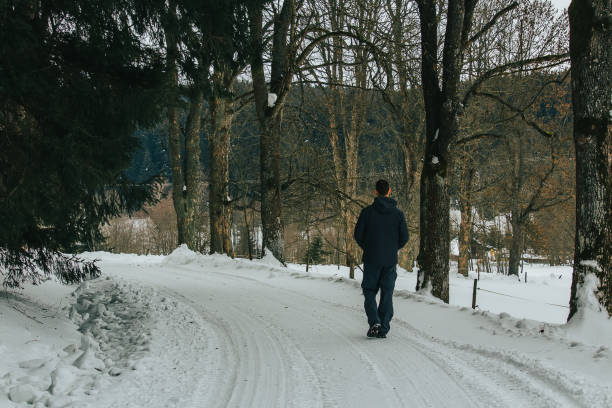istock Young man walking in winter czech landscape on forest path 1127241308