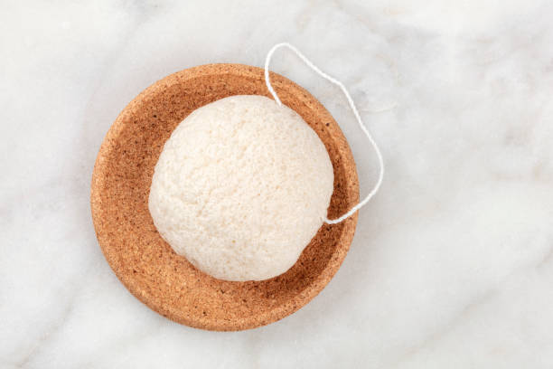 An overhead photo of a natural biodegradable Konjac sponge, shot from the top with a place for text An overhead photo of a natural biodegradable Konjac sponge, shot from the top with a place for text bath sponge photos stock pictures, royalty-free photos & images