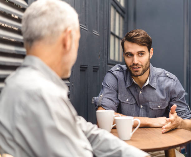 istock Businessman talking to colleague in office cafe 1127242426