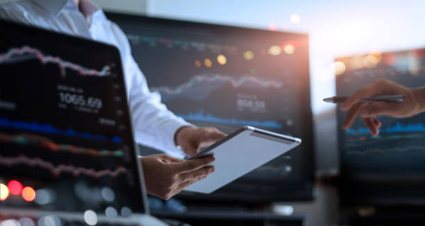 istock Business team working together. Businessman using tablet for analyzing data stock market in monitoring room with team pointing on the data presented in the chart on screen, forex trading graph, stock exchange trading online, financial investment concept. 1127243234