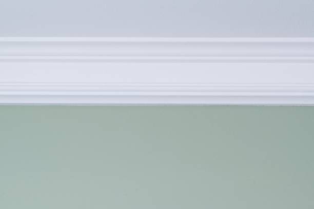istock White ceiling molding, green painted wall. Interior details close-up 1127243444