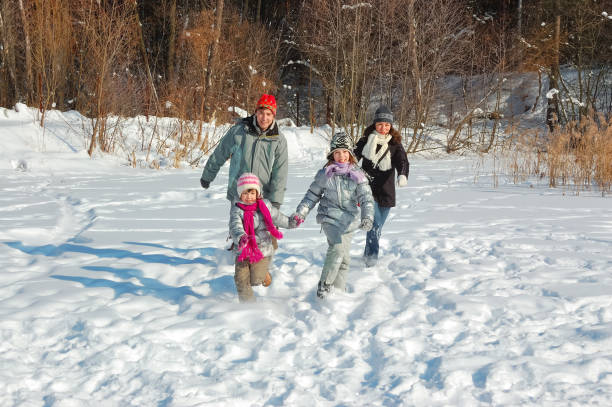 istock Happy family in winter, having fun with snow outdoors on weekend 1127244376