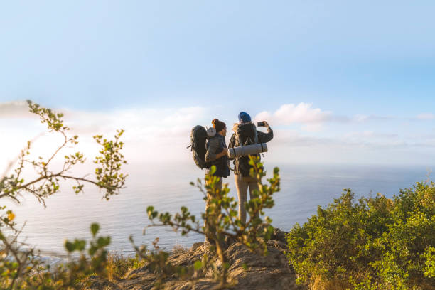 istock Rear view of backpackers over looking sea 1127244562