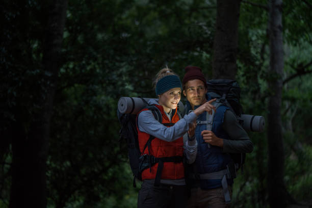 Woman showing something to man while hiking