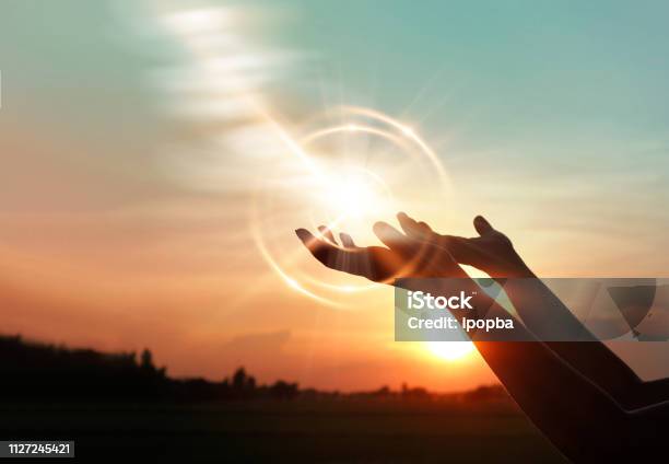 Woman Hands Praying For Blessing From God On Sunset Background Stock Photo - Download Image Now