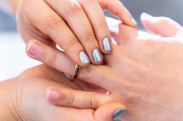 istock Wedding theme, Bride putting ring on groom hand, and they holding hands with a nice manicure neat. 1127245598