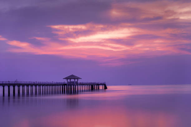 istock Wooded bridge in the port between sunrise. 1127248303