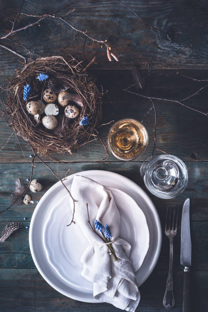 istock Table decoration for Easter with Plates, Covers, Bird's Nest. Happy Easter 1127249530