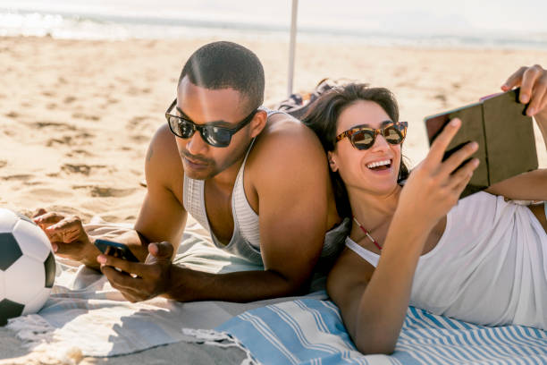istock Couple relaxing at beach during summer vacation 1127250183