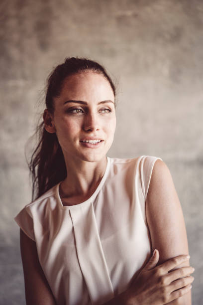 istock Thoughtful young woman against wall 1127251266
