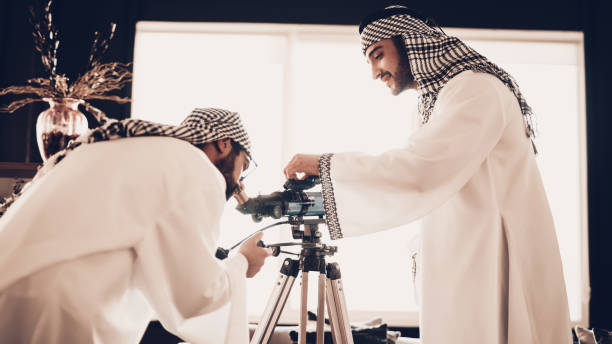 istock Arab looking at Telescope and another set up it 1127251508
